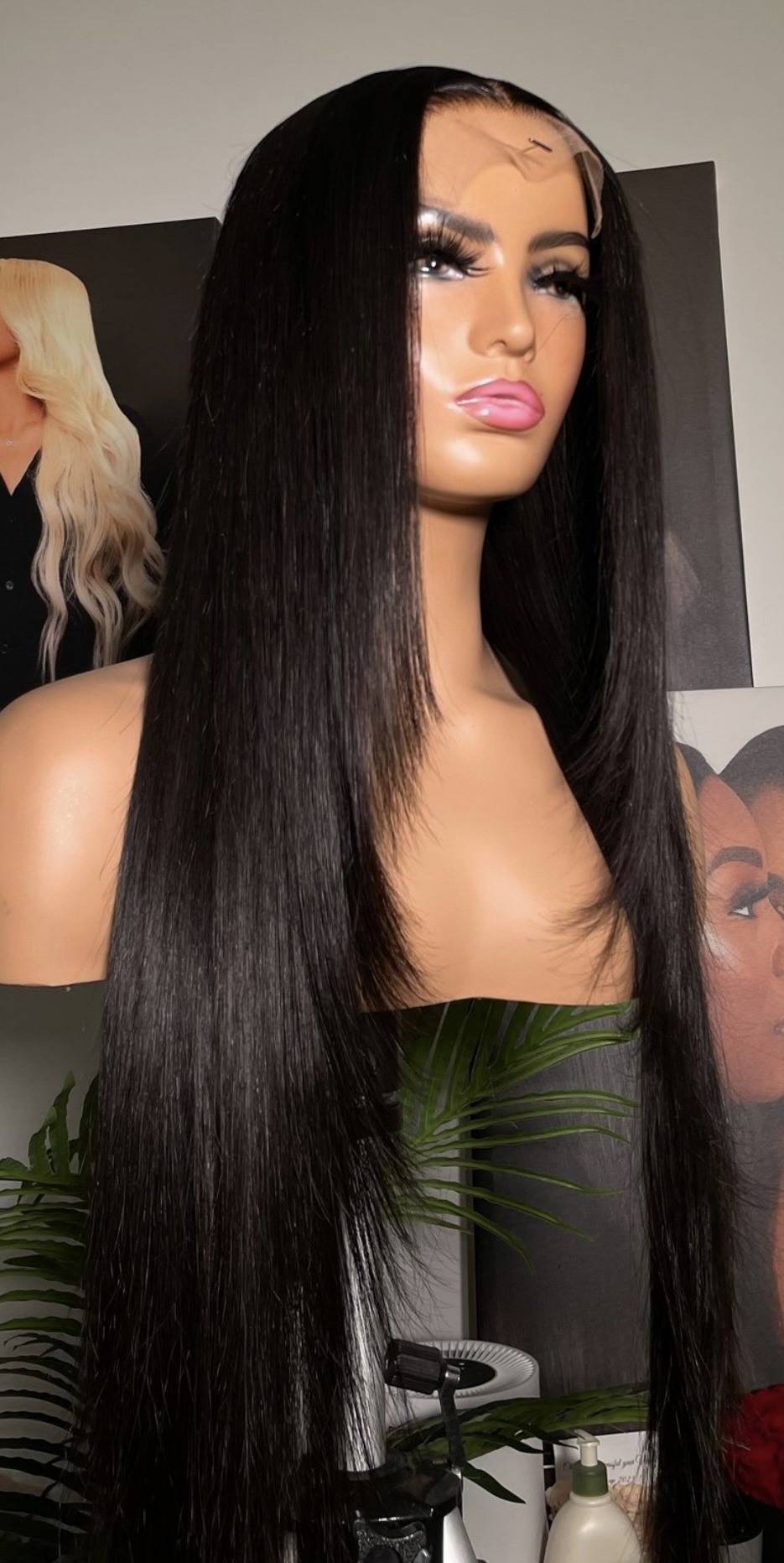 Jet black lace-front wig with a center part and feathered face-framing layers